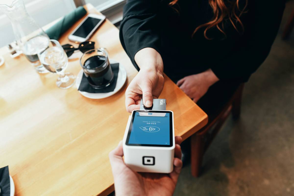 Metal credit card holder enjoying Fine Dining Discounts at upscale restaurant