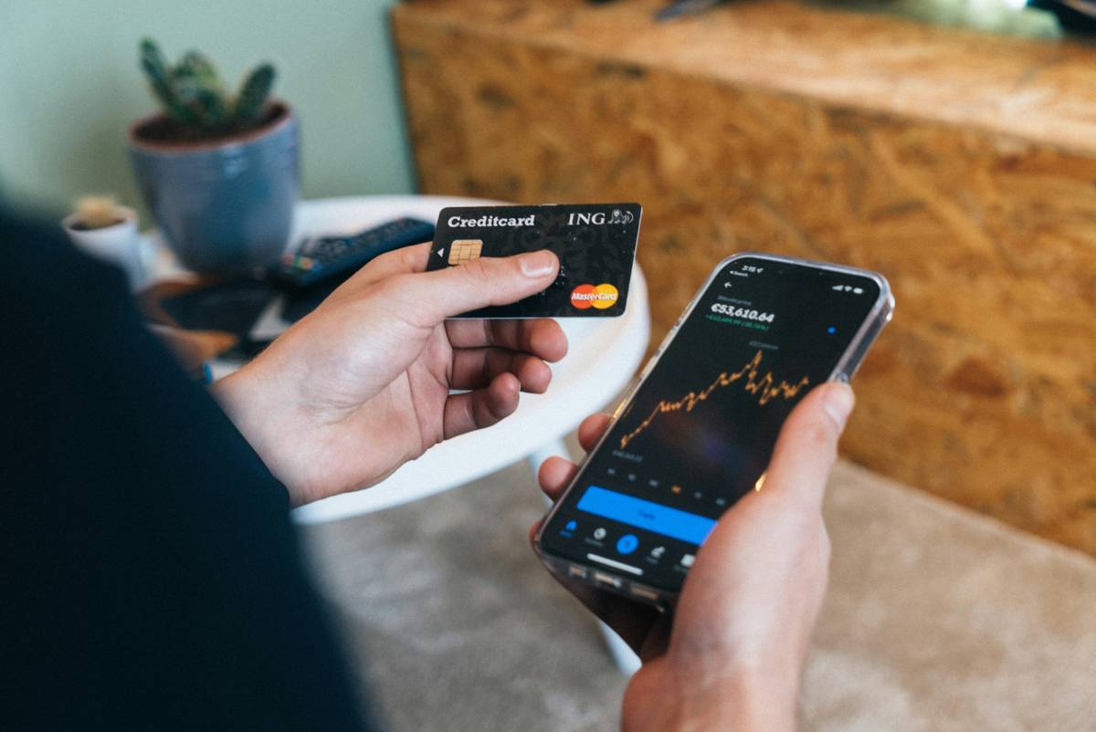 Metal credit card user browsing shop reward tips on laptop