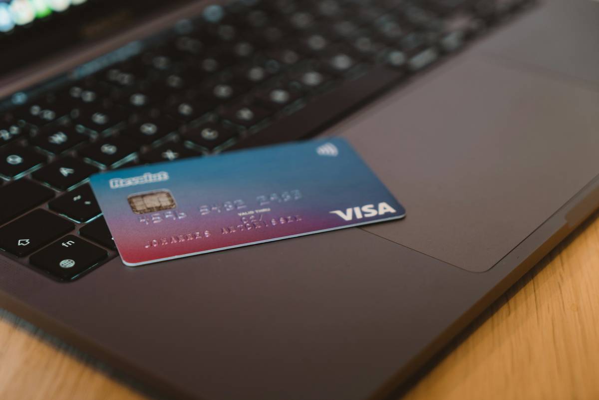 Golfer using metal credit card for Golf Course Access at clubhouse entrance