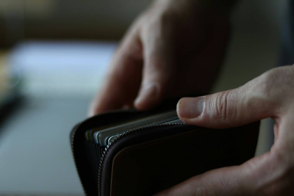 Metal credit card with RFID-blocking sleeve showing cardholder protection concept