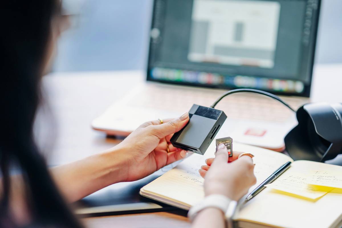 hand holding metal credit card with reward rate calculation overlay